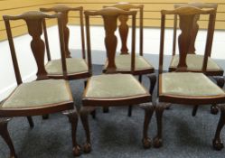 A set of six mahogany dining chairs with shaped splat backs, carved ball and claw feet and drop-in