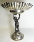 An EPNS and white metal tazza with swirl decorated dish and base and having a cherubic stand