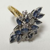 A sapphire and diamond floral ring in a yellow gold setting, 9gms