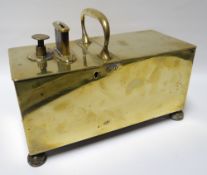 A nineteenth century brass tobacco dispenser box with penny slot, carrying handle and hinged lid,