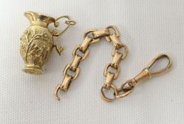 A 9ct yellow gold ewer charm, 8gms; together with a believed 9ct part-chain