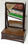 A small mahogany (faded) toilet mirror with single curved drawer, circa 1820, 12.5ins wide (32cms)