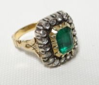 A nineteenth century ring with centre emerald-cut emerald, 8mms long, raised over a rectangular