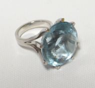 A large modern aquamarine ring, 21mm diam in a (750) 18ct white gold eight-claw setting, 19.3gms