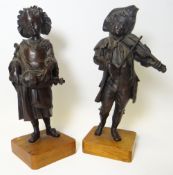 A pair of bronze / metallic street musician figures on wooden bases, 8ins high (20cms)