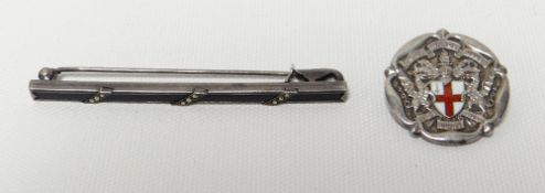 A white metal bar brooch and a silver enamelled crest brooch for UNITED WARDS CLUB