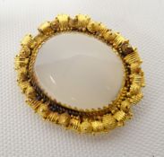 A large moonstone brooch set in non-marked believed gold fancy frame, 36mms long