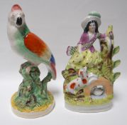 A nineteenth century Staffordshire parrot and similar period Highland lady with animals model
