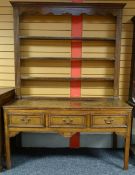 An inlaid oak open dresser with three drawers to the base and four shelves to the rack, circa