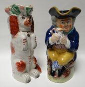 A nineteenth century Staffordshire red and white seated spaniel spill-holder, 9.75ins high (