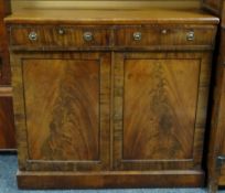 A figured mahogany cupboard base with two upper drawers, circa 1840 46.5ins wide (118cms)