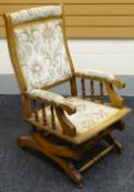 An American rocking chair with upholstered seat and back, circa 1900
