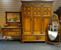 A good polished oak three piece bedroom set comprising triple wardrobe with base drawers, barley-