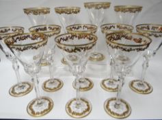A set of twelve gilded high glass goblets with faceted and etched stems, probably European, 9ins
