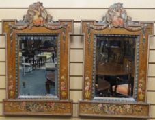 A fine pair of painted satinwood framed beveled wall-mirrors, Italianate decorated with flowers,