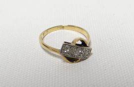 An 18ct yellow gold cross-over ring with row of three diamonds, 3.55gms