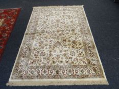 Ivory ground Kashmir rug, 227 x 154 cms
