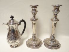 A pair of circular based EPNS candleholders and an EP coffee pot with ebonised handle