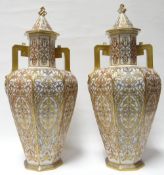 A pair of Royal Crown Derby octagonal based baluster covered-vases with twin-handles and decorated