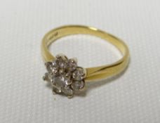 A diamond floral cluster ring in an 18ct yellow gold setting