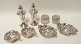 A pair of North American silver peperettes of tapering form on spread-out feet together with two