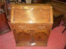 An oak bureau with ebony diamond inlay to the lid