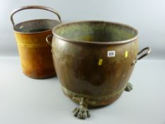 A Georgian style twin handled log bucket with brass carrying handles and hairy paw feet along with a