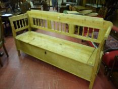 A European pine box seat settle with spindle gallery back and sides, lift-up seat with sectional
