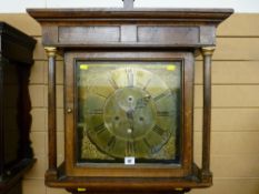 An 18th Century oak longcase clock having a square hood with turned pillars, brass dial with eight
