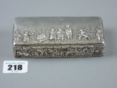 An oblong silver box, the lid decorated with figures in a landscape setting and having an all