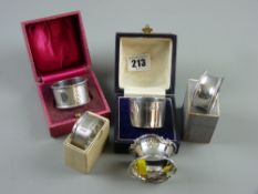 Four boxed silver napkin rings, all Birmingham assay and an unboxed silver napkin ring, Chester