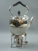 An all-silver spirit kettle of oval reeded form with shaped handle (knop and handle part ebonized)