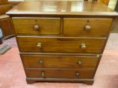 A Victorian mahogany chest of three long and two short drawers with turned wooden knobs in two
