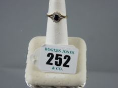 A nine carat gold dress ring with oval sapphire and surrounding tiny diamonds, 2 grms total, 'I/J'