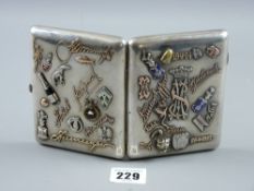 A Russian silver cigarette case with fourteen applied gold and silver signatures and monograms,