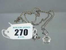 A platinum circular cluster pendant with eight diamonds, visual estimate 0.2 carat each, on a link