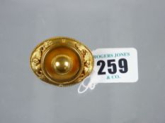 A Victorian oval pinchbeck brooch with floral and leaf decoration and rope twist border, 17.7 grms