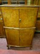 A 20th Century walnut drink's cabinet, decorative heart moulded top edge, four door cabinet base