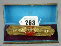 A cased Chinese yellow metal filigree seven band brooch with centre filigree and leaf decorated