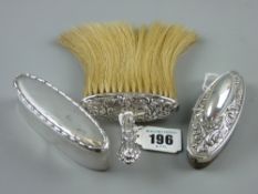 An oval lidded dressing table container with lined interior, Chester 1907; a silver buffer with