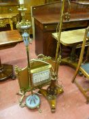 A Victorian rosewood polescreen converted to a standard lamp, a gilt metal standard lamp with