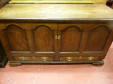 An 18th Century oak dower chest, the front having four inset arched and crossbanded panels but later