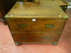 A compact mahogany two drawer campaign chest, brass bound with brass corners and with inset brass