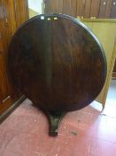 A 19th Century circular mahogany breakfast table on a segmented column and tri-form base with pot