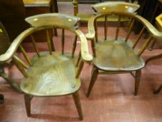 A pair of 19th Century smoker's bow armchairs, 79 x 62 cms (some restoration required)