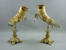 A pair of horn table cornucopia on cast Rococo style brass stands, 37 cms high