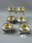 A set of six finely decorated silver circular salts (a set of four plus two) with raised floral