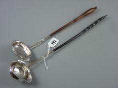 An 18th Century silver ladle with lipped bowl, dot decorated handle on the upper side with