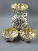 Two pairs of heavily decorated circular silver fruit or sweetmeats bowls, all with outer raised