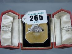 A platinum and diamond dress ring having thirteen oval set diamonds comprising a central row of